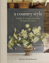 Book cover of 'A Country Style' by Harriet Thistlethwayte with a decorative cabinet and floral arrangement.