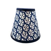Blue clip on lampshade with white flower motif on white background