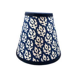 Blue clip on lampshade with white flower motif on white background