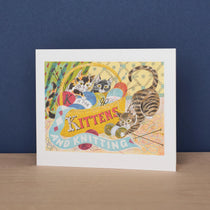 Framed artwork with cats and knitting-themed text on a blue background