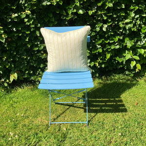 stripe cushion on blue chair on lawn