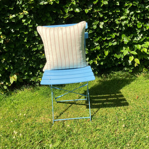 stripe cushion on blue chair on lawn