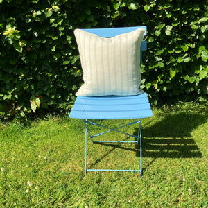 stripe cushion on blue chair on lawn
