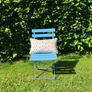 Multi colour rectangle cushion on blue chair in garden