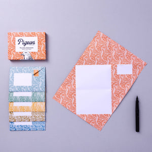 Pigeon stationery set with patterned envelopes and boxes on a gray background