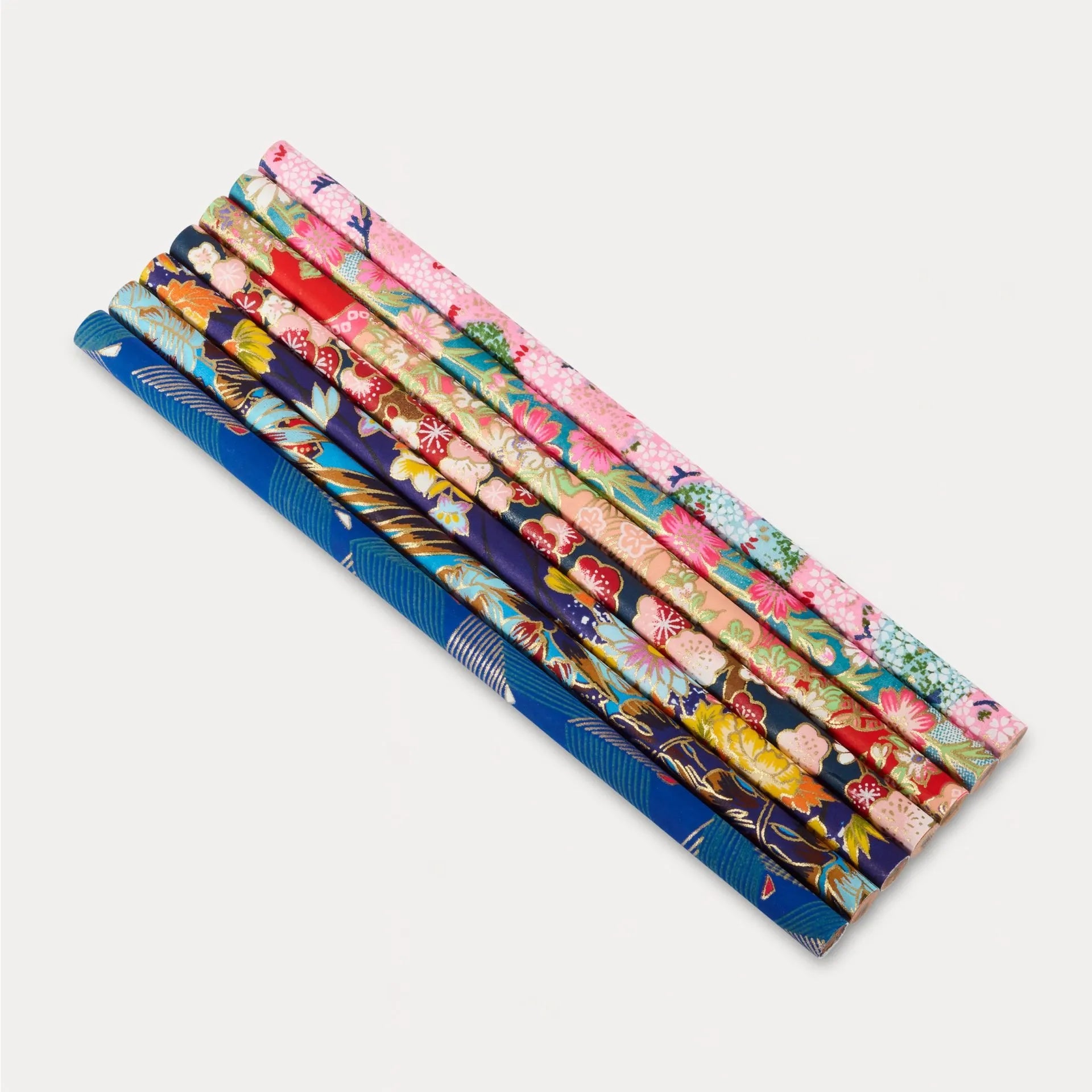 Set of colorful patterned straws on a white background
