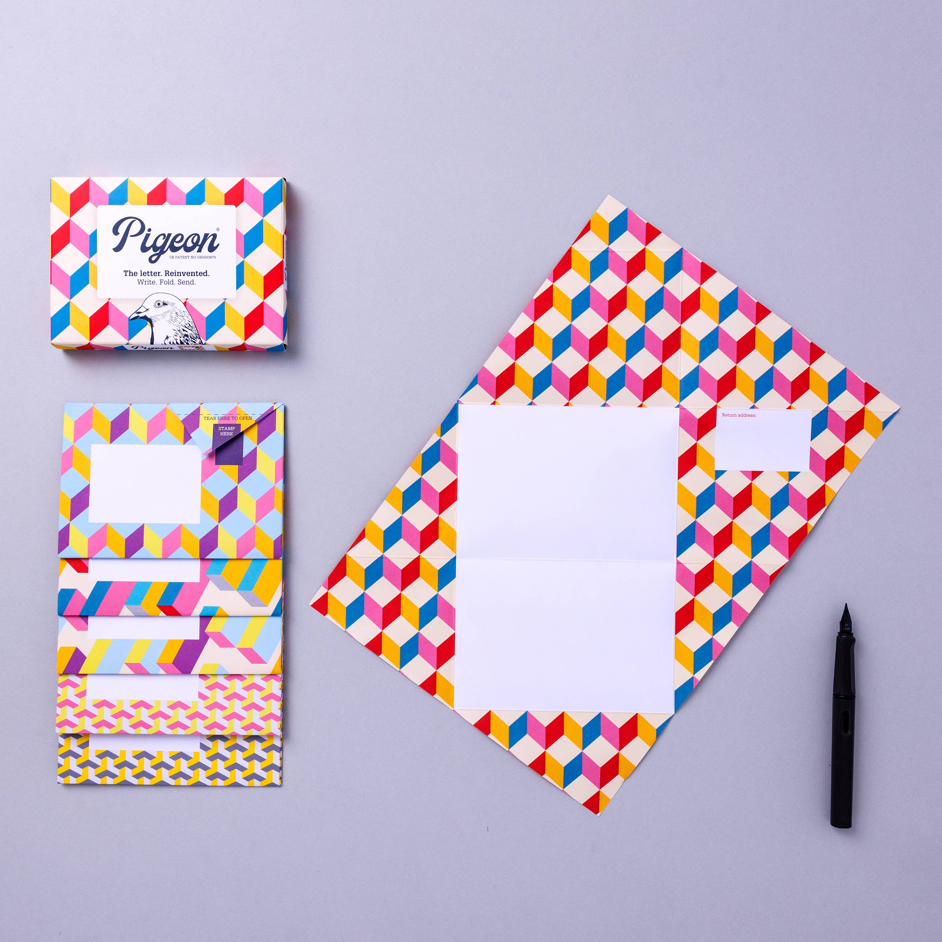 Colorful geometric patterned stationery set on a gray background