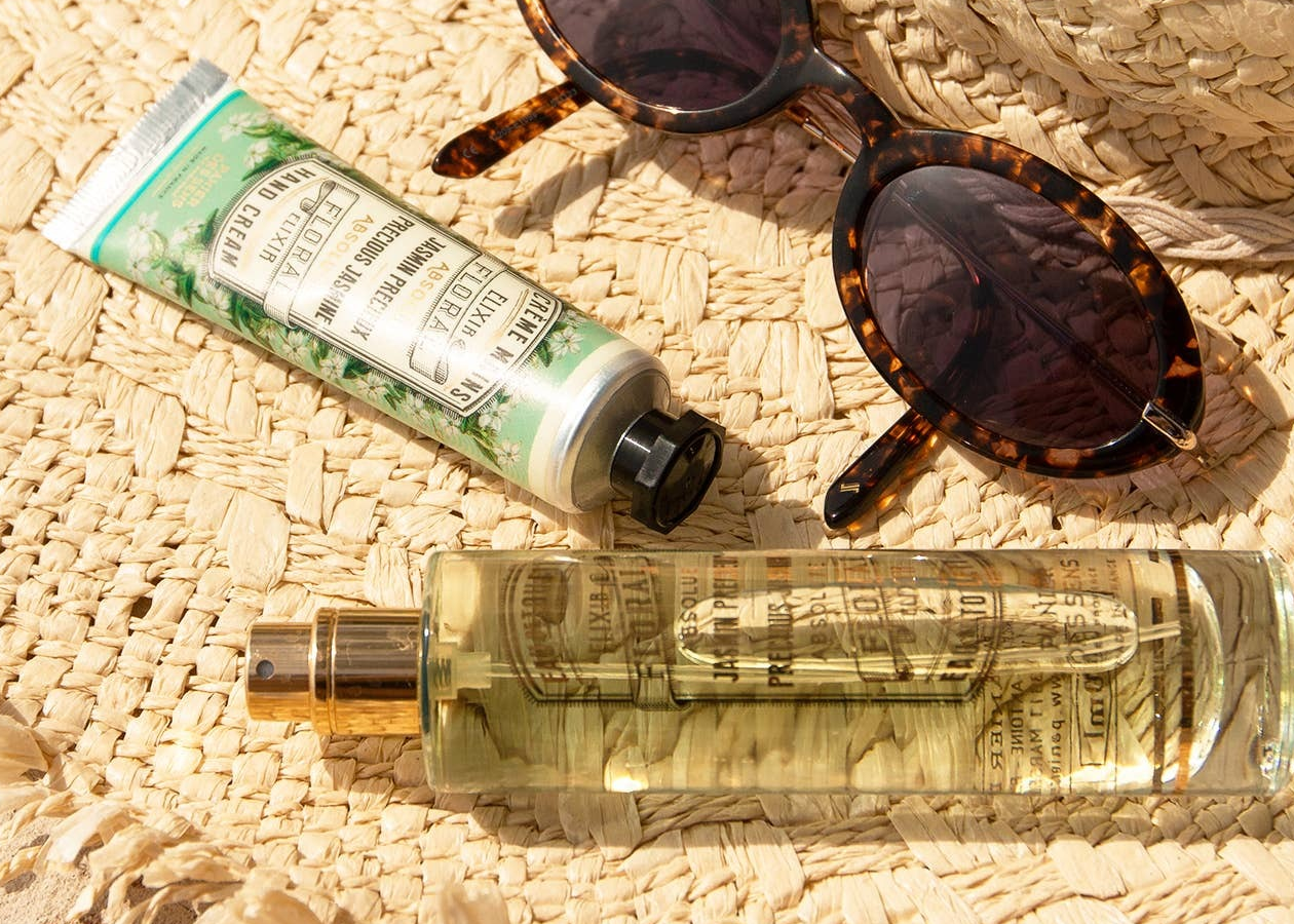 sunglasses hand cream and oil on straw sun hat
